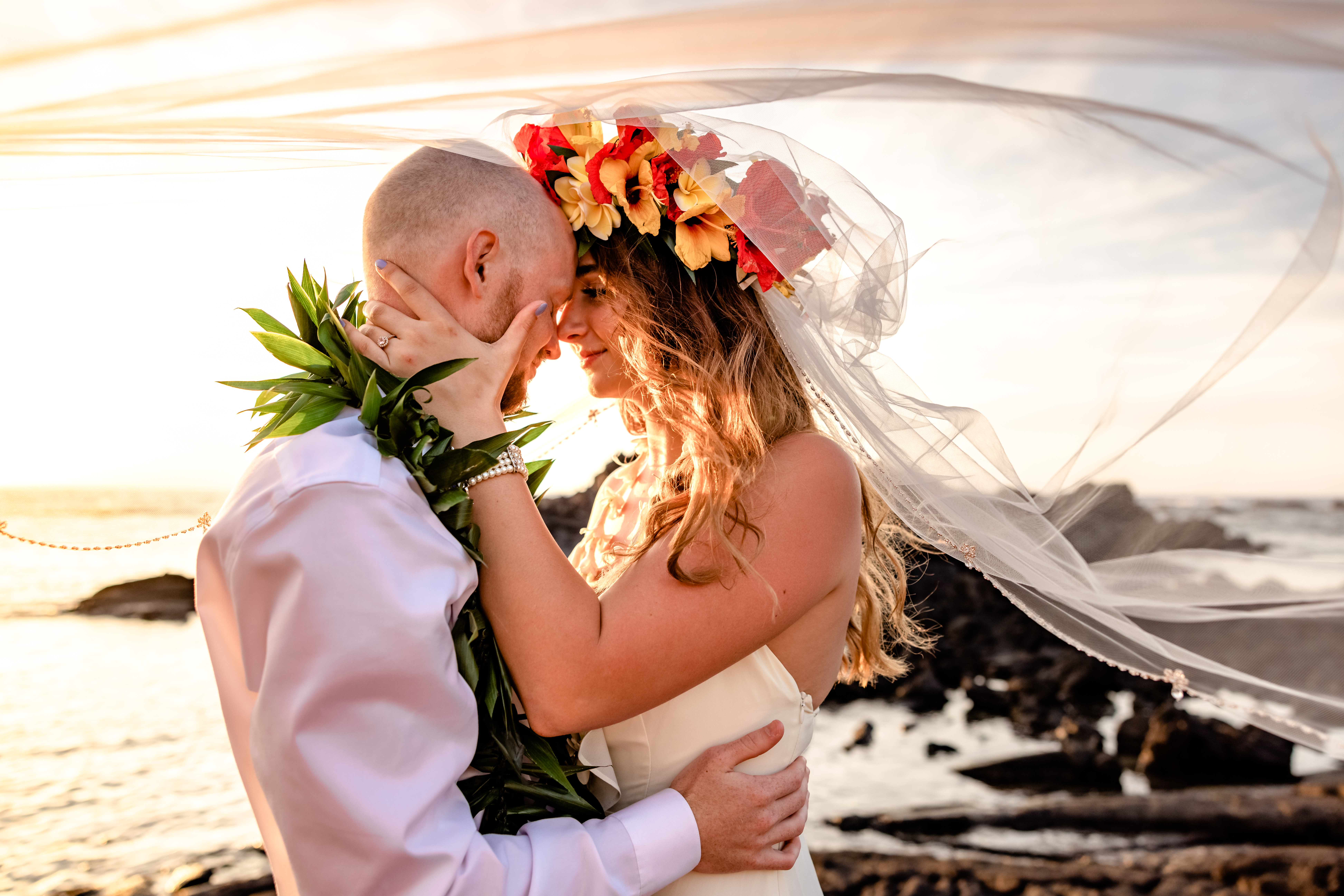 Couple enjoying the ocean breeze during their photo session after their Big Island elopement
