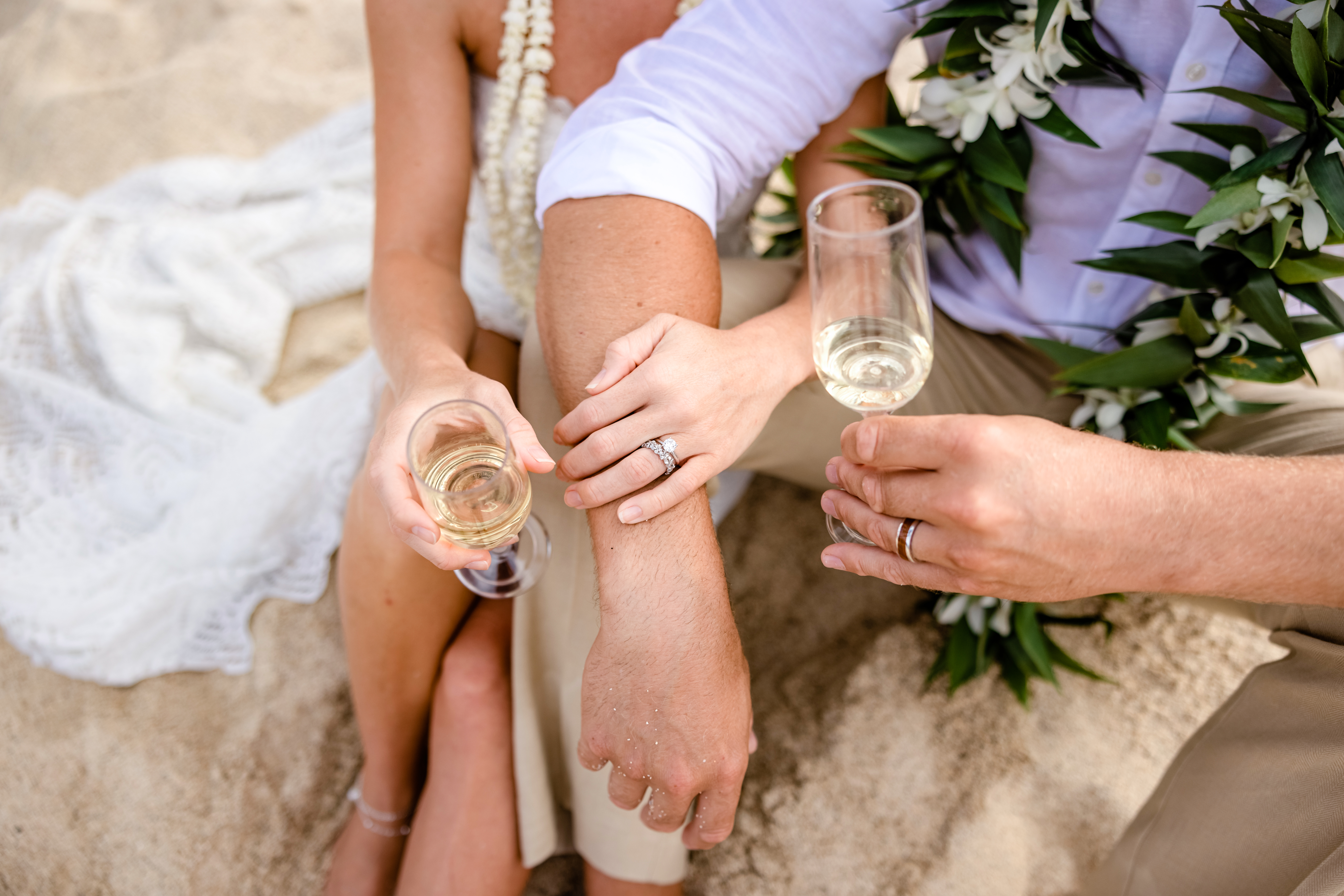 Couple enjoying some bubby on a private beach after their Big Island elopement