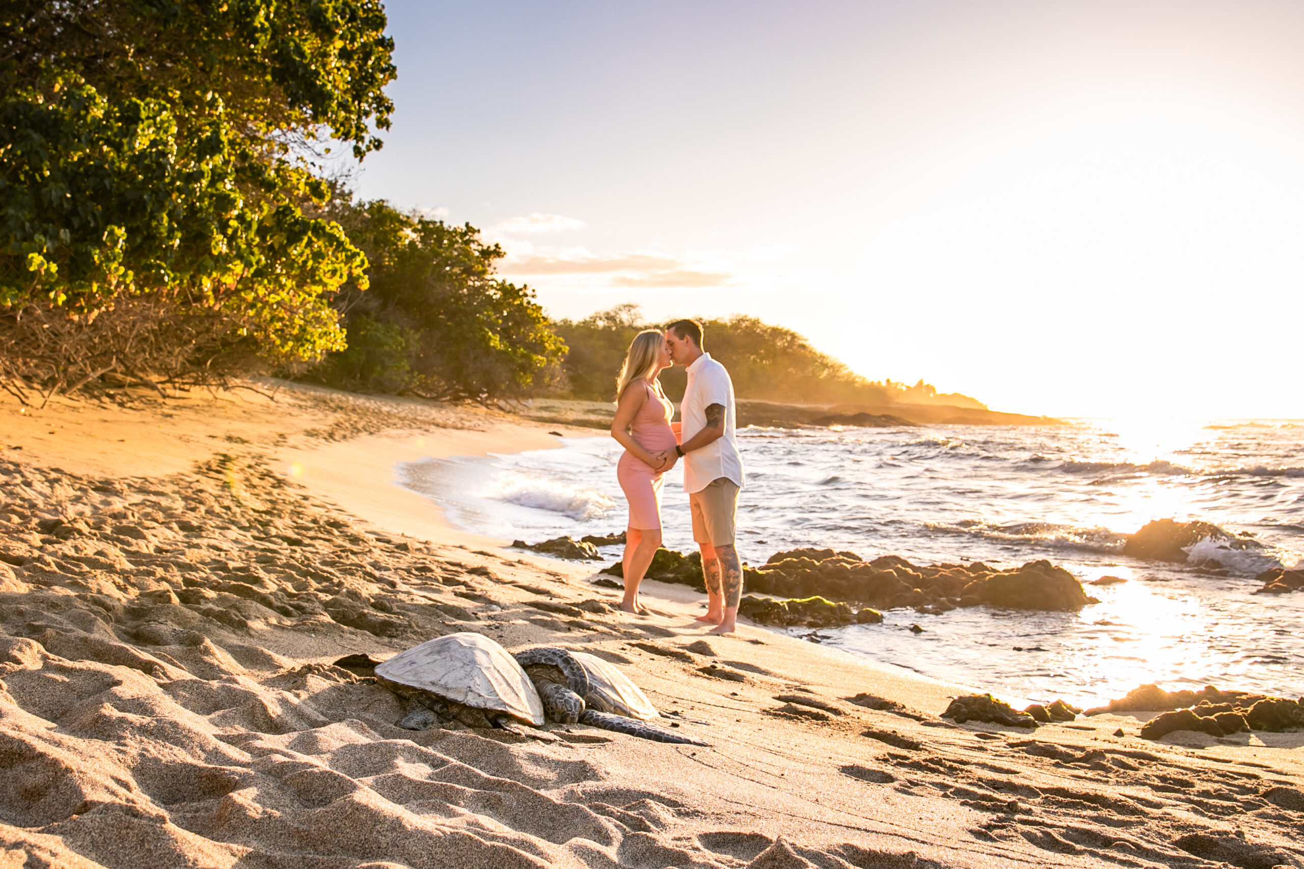 Couple on Big Island beach taking maternity photos